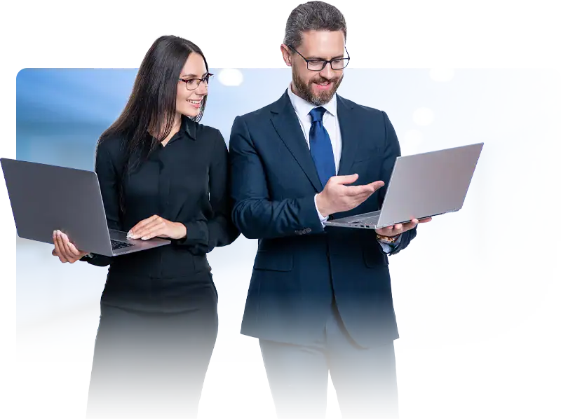 businessman and businesswoman holding open laptops