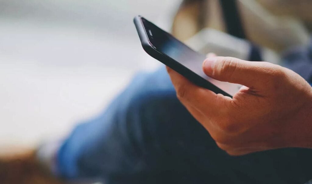 sitting with phone in hand