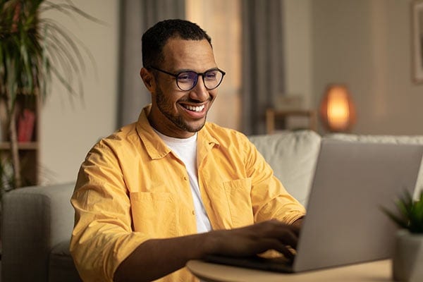 young black man working on laptop